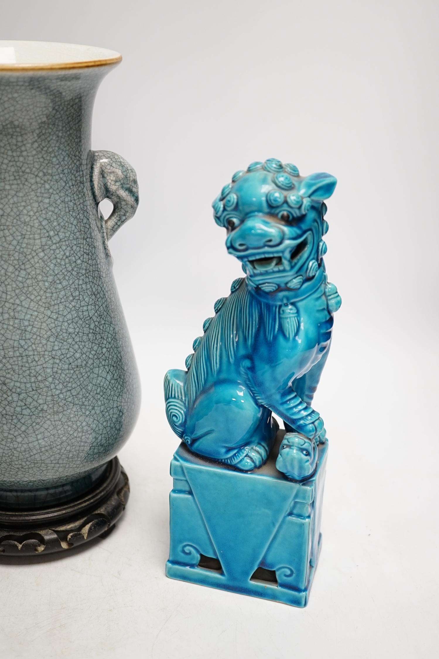 A pair of early 20th century Chinese turquoise glazed dogs of fo and a crackle glazed vase on stand, tallest 29cm. Condition - good, vase has drill hole to base